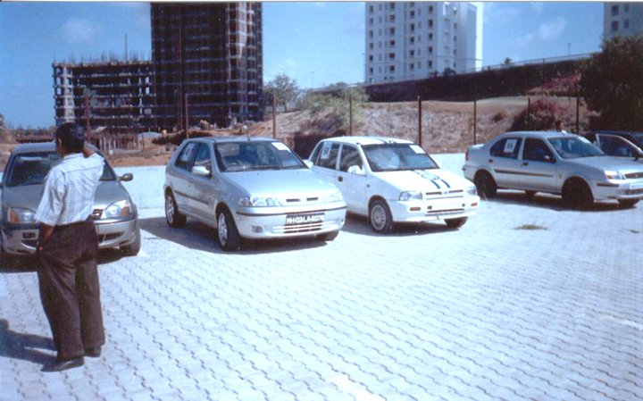 Pre-race: here are the cars along with mine waiting in the parking lot in the morning before the start of the race. The white car with blue strip is the MARUTI ZEN which was my friend's car. It has a 1000cc engine. The other 2 cars are same FORD IKON cars having 1600 cc engine. 
